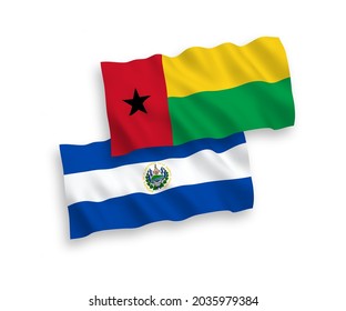National vector fabric wave flags of Republic of El Salvador and Republic of Guinea Bissau isolated on white background. 1 to 2 proportion.