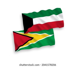 National vector fabric wave flags of Co-operative Republic of Guyana and Kuwait isolated on white background. 1 to 2 proportion.