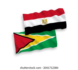 National vector fabric wave flags of Co-operative Republic of Guyana and Egypt isolated on white background. 1 to 2 proportion.