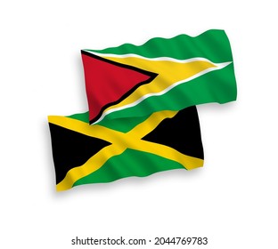 National vector fabric wave flags of Co-operative Republic of Guyana and Jamaica isolated on white background. 1 to 2 proportion.