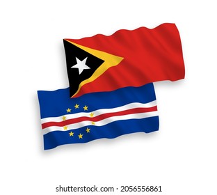 National vector fabric wave flags of Republic of Cabo Verde and East Timor isolated on white background. 1 to 2 proportion.