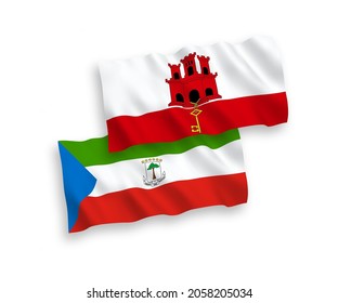 National vector fabric wave flags of Republic of Equatorial Guinea and Gibraltar isolated on white background. 1 to 2 proportion.