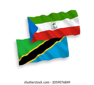 National vector fabric wave flags of Republic of Equatorial Guinea and Tanzania isolated on white background. 1 to 2 proportion.