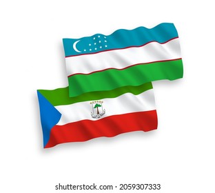 National vector fabric wave flags of Republic of Equatorial Guinea and Uzbekistan isolated on white background. 1 to 2 proportion.