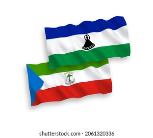 National vector fabric wave flags of Republic of Equatorial Guinea and Lesotho isolated on white background. 1 to 2 proportion.