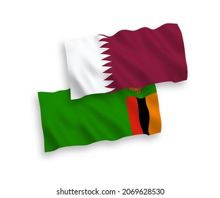 National vector fabric wave flags of Republic of Zambia and Qatar isolated on white background. 1 to 2 proportion.