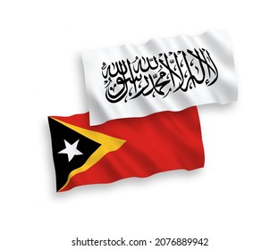 National vector fabric wave flags of Taliban and East Timor isolated on white background. 1 to 2 proportion.