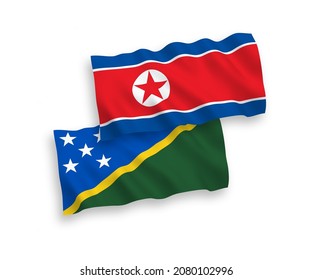 National vector fabric wave flags of North Korea and Solomon Islands isolated on white background. 1 to 2 proportion.