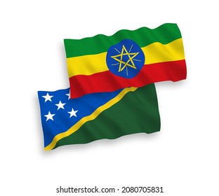 National vector fabric wave flags of Solomon Islands and Ethiopia isolated on white background. 1 to 2 proportion.