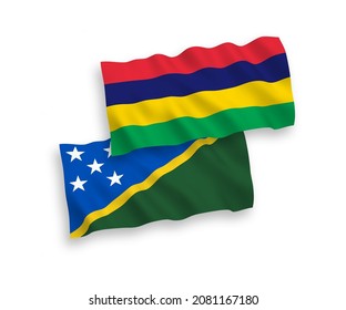National vector fabric wave flags of Solomon Islands and Republic of Mauritius isolated on white background. 1 to 2 proportion.