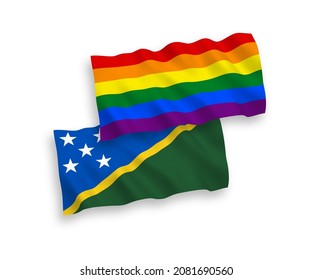National vector fabric wave flags of Solomon Islands and Rainbow gay pride isolated on white background. 1 to 2 proportion.