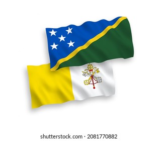National vector fabric wave flags of Solomon Islands and Vatican isolated on white background. 1 to 2 proportion.