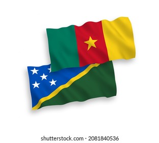 National vector fabric wave flags of Solomon Islands and Cameroon isolated on white background. 1 to 2 proportion.
