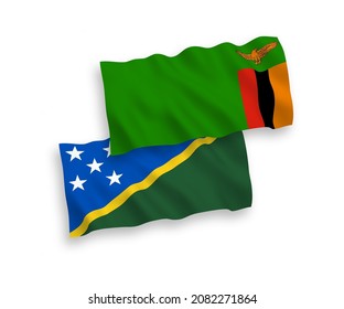 National vector fabric wave flags of Solomon Islands and Republic of Zambia isolated on white background. 1 to 2 proportion.