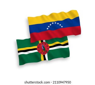 National vector fabric wave flags of Venezuela and Dominica isolated on white background. 1 to 2 proportion.