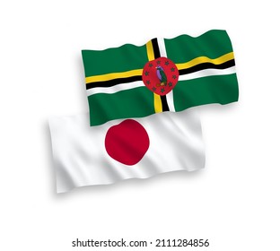 National vector fabric wave flags of Japan and Dominica isolated on white background. 1 to 2 proportion.
