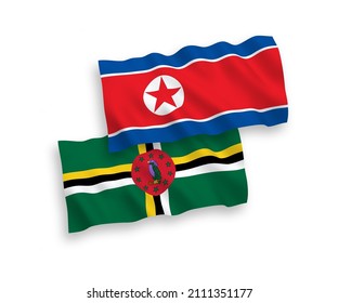 National vector fabric wave flags of North Korea and Dominica isolated on white background. 1 to 2 proportion.