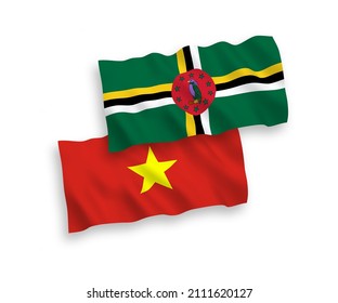 National vector fabric wave flags of Dominica and Vietnam isolated on white background. 1 to 2 proportion.