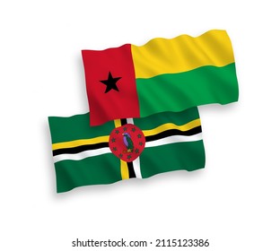 National vector fabric wave flags of Dominica and Republic of Guinea Bissau isolated on white background. 1 to 2 proportion.