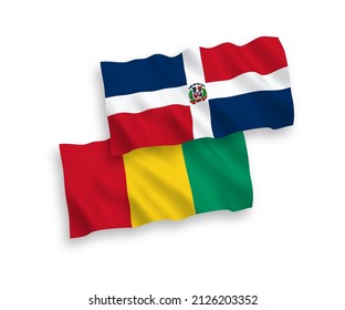 National vector fabric wave flags of Dominican Republic and Guinea isolated on white background. 1 to 2 proportion.