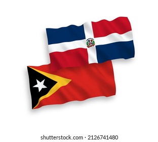 National vector fabric wave flags of Dominican Republic and East Timor isolated on white background. 1 to 2 proportion.