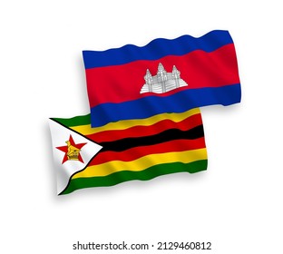 National vector fabric wave flags of Kingdom of Cambodia and Zimbabwe isolated on white background. 1 to 2 proportion.