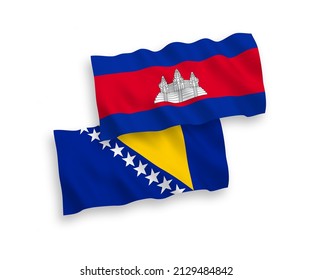 National vector fabric wave flags of Kingdom of Cambodia and Bosnia and Herzegovina isolated on white background. 1 to 2 proportion.