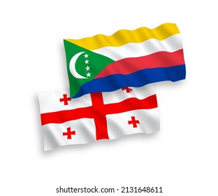 National vector fabric wave flags of Union of the Comoros and Georgia isolated on white background. 1 to 2 proportion.