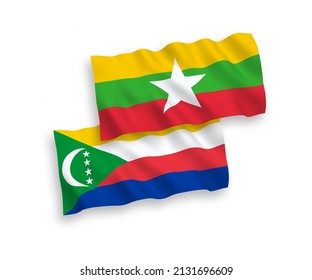 National vector fabric wave flags of Union of the Comoros and Myanmar isolated on white background. 1 to 2 proportion.