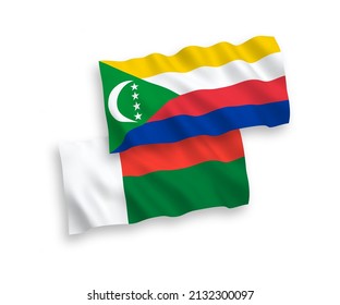 Nationale Vektor-Wellen-Flaggen von Union der Komoren und Madagaskar einzeln auf weißem Hintergrund. 1 bis 2 %.