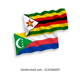 National vector fabric wave flags of Union of the Comoros and Zimbabwe isolated on white background. 1 to 2 proportion.