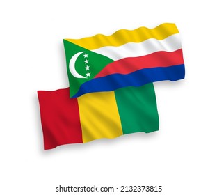 National vector fabric wave flags of Union of the Comoros and Guinea isolated on white background. 1 to 2 proportion.