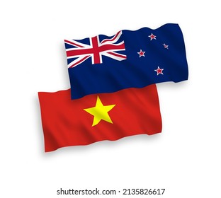 National vector fabric wave flags of New Zealand and Vietnam isolated on white background. 1 to 2 proportion.