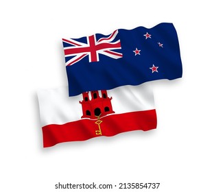 National vector fabric wave flags of New Zealand and Gibraltar isolated on white background. 1 to 2 proportion.