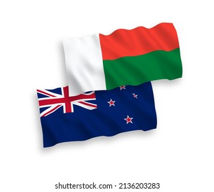 National vector fabric wave flags of New Zealand and Madagascar isolated on white background. 1 to 2 proportion.