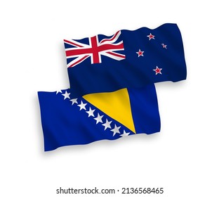 National vector fabric wave flags of New Zealand and Bosnia and Herzegovina isolated on white background. 1 to 2 proportion.