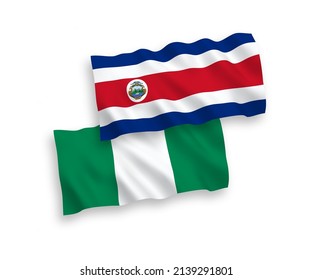 National vector fabric wave flags of Republic of Costa Rica and Nigeria isolated on white background. 1 to 2 proportion.