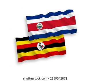 National vector fabric wave flags of Republic of Costa Rica and Uganda isolated on white background. 1 to 2 proportion.