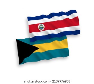 National vector fabric wave flags of Republic of Costa Rica and Commonwealth of The Bahamas isolated on white background. 1 to 2 proportion.