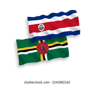 National vector fabric wave flags of Republic of Costa Rica and Dominica isolated on white background. 1 to 2 proportion.