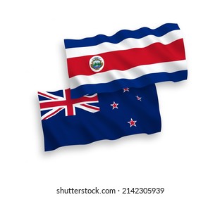 National vector fabric wave flags of Republic of Costa Rica and New Zealand isolated on white background. 1 to 2 proportion.