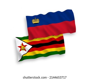 National vector fabric wave flags of Liechtenstein and Zimbabwe isolated on white background. 1 to 2 proportion.