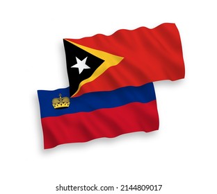 National vector fabric wave flags of Liechtenstein and East Timor isolated on white background. 1 to 2 proportion.
