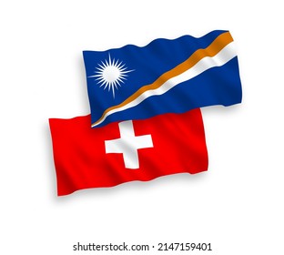 National vector fabric wave flags of Republic of the Marshall Islands and Switzerland isolated on white background. 1 to 2 proportion.
