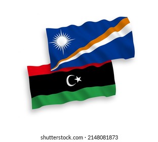 National vector fabric wave flags of Republic of the Marshall Islands and Libya isolated on white background. 1 to 2 proportion.