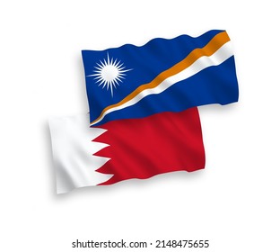 National vector fabric wave flags of Republic of the Marshall Islands and Bahrain isolated on white background. 1 to 2 proportion.