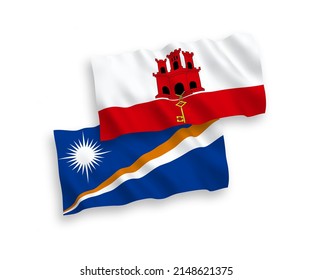 National vector fabric wave flags of Republic of the Marshall Islands and Gibraltar isolated on white background. 1 to 2 proportion.