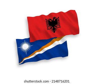 National vector fabric wave flags of Republic of the Marshall Islands and Albania isolated on white background. 1 to 2 proportion.