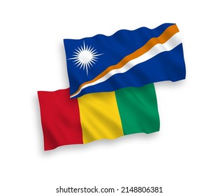 National vector fabric wave flags of Republic of the Marshall Islands and Guinea isolated on white background. 1 to 2 proportion.