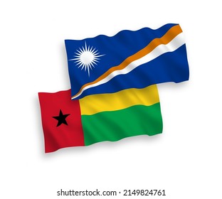 National vector fabric wave flags of Republic of the Marshall Islands and Republic of Guinea Bissau isolated on white background. 1 to 2 proportion.